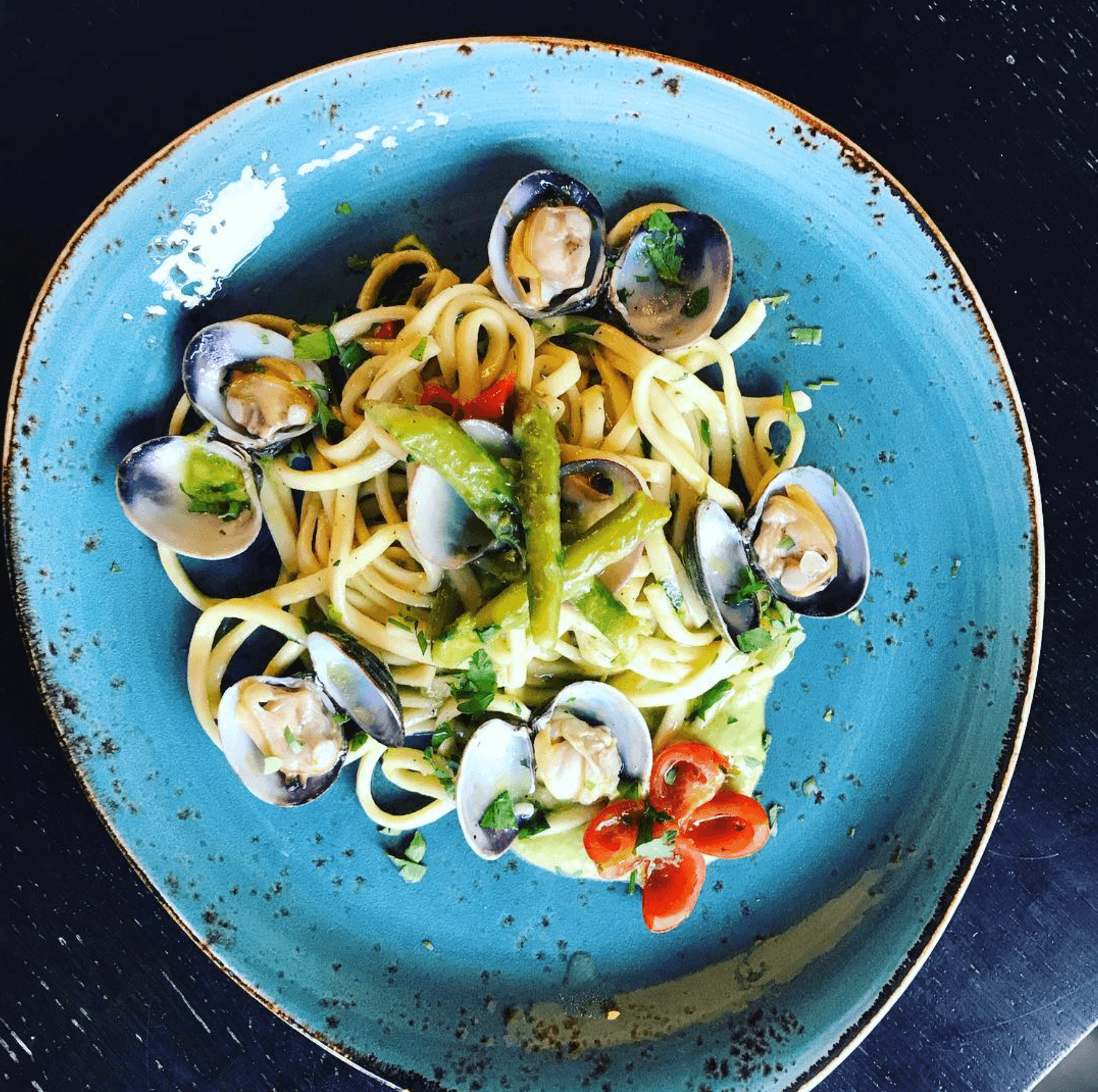 Linguine alle Vongole — linguine with clams, asparagus and cherry tomato in a hand-made blue stoneware bowl